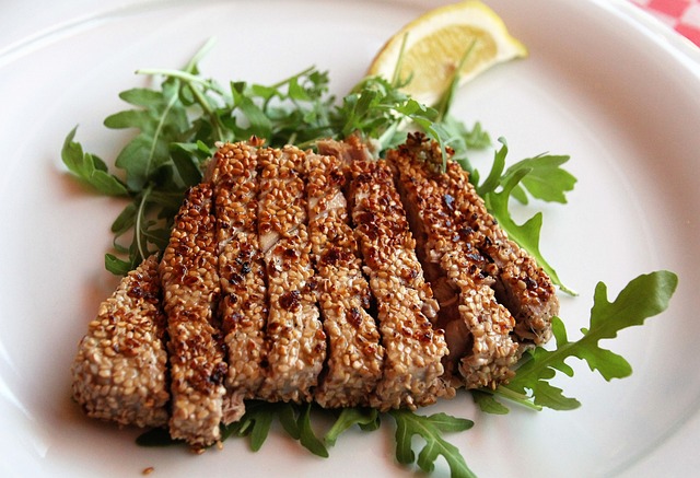 slices of tuna with sunflower with a slice of lemon on the side