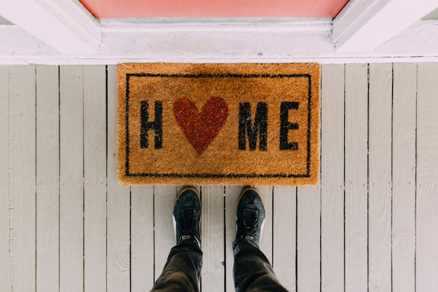 Door mat with the word home and the shape of a heart